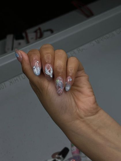 Another shot of the glistening, detailed nail art, showing the intricate line work and texture.