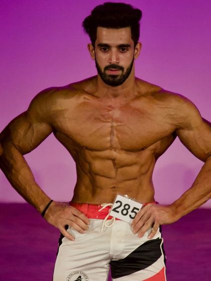 Front relaxed pose on stage.