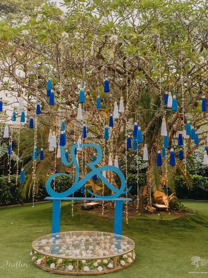 A wishing tree adorned with blue and white tassels and a custom logo for the couple. This interactive element for Yasha and Rahil's Haldi served as a beautiful and meaningful centerpiece.