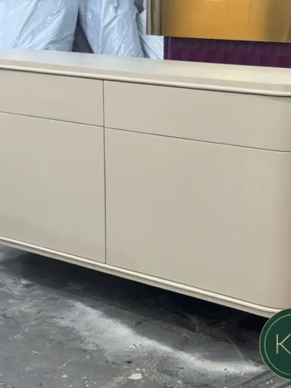 A sleek, modern console table with a smooth, curved silhouette and a neutral-toned finish. This minimalist piece is designed to add a touch of sophistication to an entryway or living room.