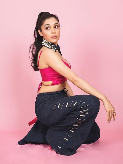 A profile shot of Eisha Singh, giving a different angle of the creative outfit and highlighting her elegant posture.