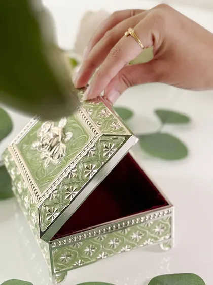 Opening the box reveals the rich, contrasting velvet interior, designed to protect your most cherished jewelry. It is a perfect marriage of external beauty and internal care.