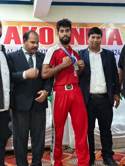 A team member proudly displaying his medal at the National Kickboxing Championships in Jaipur. A testament to his hard work.