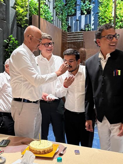 A senior colleague shares a piece of birthday cake. These interactions strengthen the bonds within our legal fraternity.