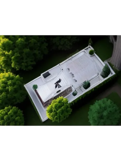 The 'After' shot of a landscaping project. This top-down view clearly shows the finished design with lush green trees and a clean, white rooftop area.