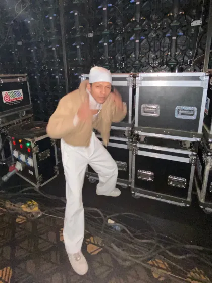 A candid, energetic moment backstage. Even before the performance, the vibe is everything. I make sure my crew is hyped and ready to kill it.