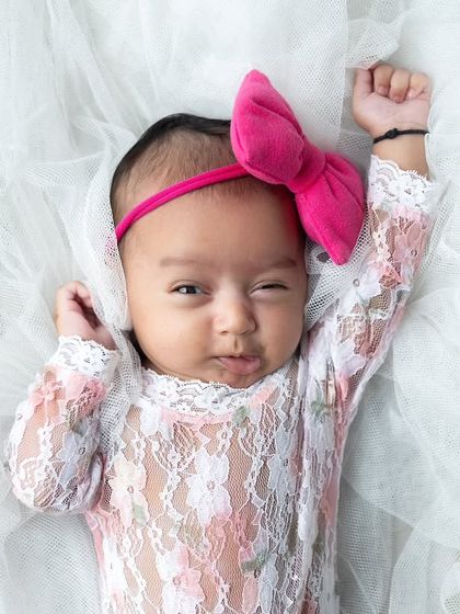 A funny little wink and expression from this baby girl. These are the unique moments you'll want to remember forever.