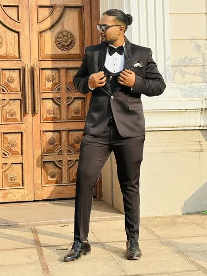 I believe the groom should look just as sharp. This classic black tuxedo is tailored to perfection, ensuring a dapper and timeless look for any pre-wedding shoot or formal event.