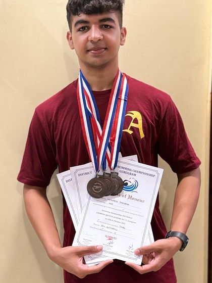 Yatharth Thakran proudly displaying the 5 medals he won at a recent championship, all with new personal best times.