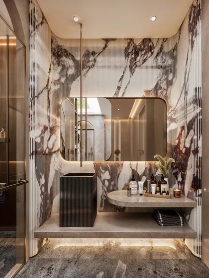 A detail shot of the vanity area, showcasing the book-matched marble and the unique, fluted black pedestal sink.