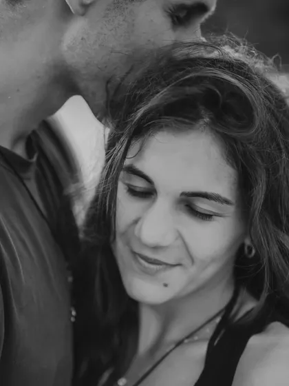 A gentle and affectionate moment captured in black and white on a Bali beach. This timeless portrait highlights the quiet, tender side of the couple's relationship.