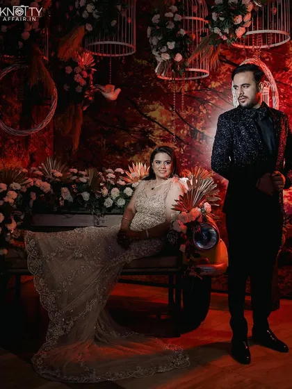 A highly stylized portrait of the couple against a vibrant red backdrop with a scooter prop. This shows our ability to create unique, editorial-style images.