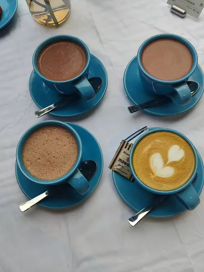 A shot from a coffee event with Blue Tokai, showcasing their winter menu. The vibrant blue cups create a strong brand presence in the photo.