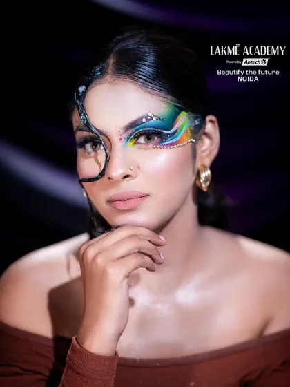 A stunning multi-colored graphic eye makeup look. This student work showcases advanced skills in blending, line work, and rhinestone application.