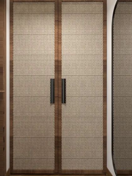 Details matter in creating a cohesive design. These wardrobe doors with a woven texture and simple black handles complement the natural and modern aesthetic of the bedroom suite.