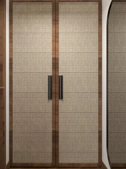 Details matter in creating a cohesive design. These wardrobe doors with a woven texture and simple black handles complement the natural and modern aesthetic of the bedroom suite.