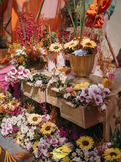 An explosion of yellow and gold for the Haldi. Sunflowers, orchids, and other vibrant blooms overflow from drawers and vases, creating a feeling of abundance and joy.