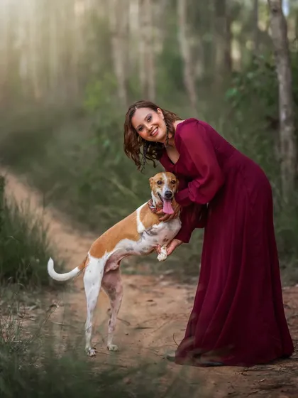 Your four-legged family members are always welcome in my photoshoots. This outdoor portrait captures the pure, joyful connection between a mother-to-be and her beloved dog, creating a memory that includes every member of the growing family.