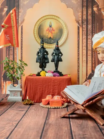A beautiful, serene moment of the little Varkari looking down at the holy book. The lighting is carefully controlled to create a soft, devotional mood.