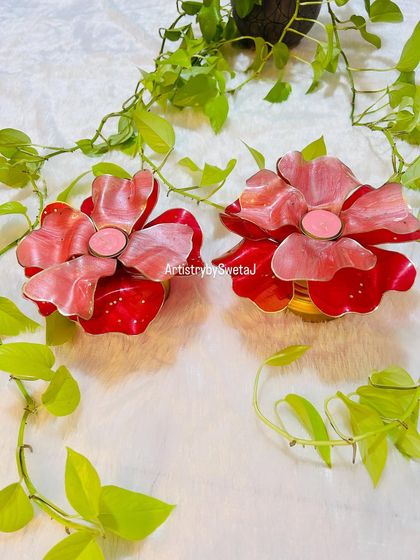 Another shot of the vibrant red and pink floral diyas, perfect for festive decor.