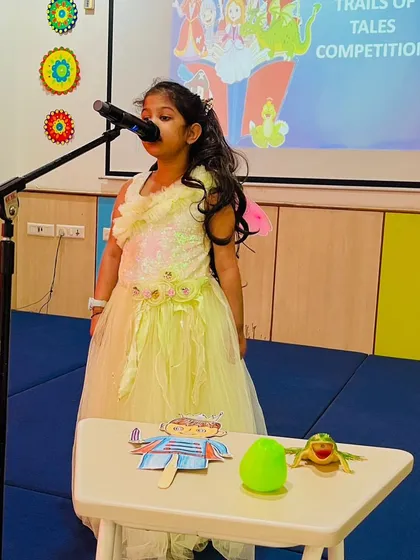 Dressed as a fairy, a young storyteller captivates her audience. We encourage students to use costumes and props to bring their tales to life, making learning a magical experience.