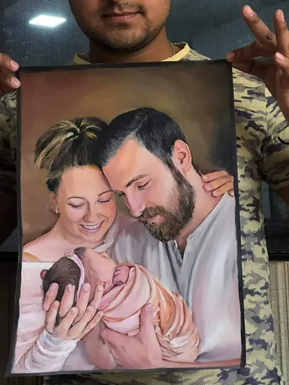 Holding up the finished family portrait for my US client. Seeing the final piece ready to be shipped is always a proud moment.