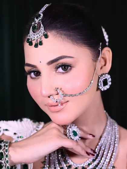 Another angle of this beautiful bridal makeup. The focus is on achieving a perfect skin finish and ensuring the makeup lasts through all the ceremonies.