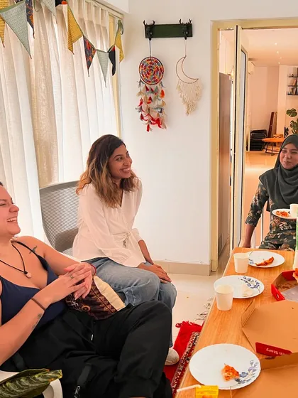 Laughter and conversation flow easily at our studio. Here, poets relax and connect over pizza after a collaborative video shoot.