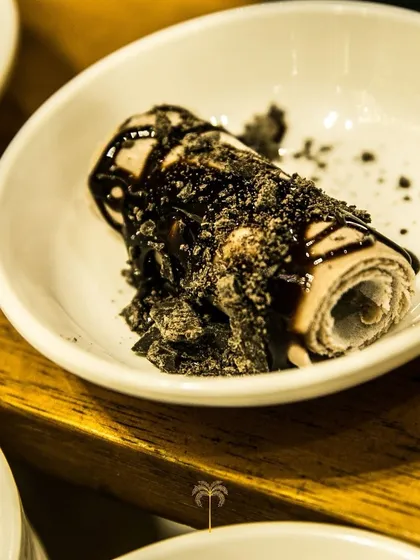 An indulgent chocolate ice cream roll topped with crushed Oreos and chocolate sauce. A decadent treat for those with a serious sweet tooth.