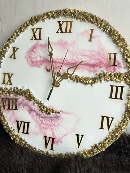 A lovely pink and white resin clock with a bold gold crystal border and Roman numerals, creating a classic yet modern look.
