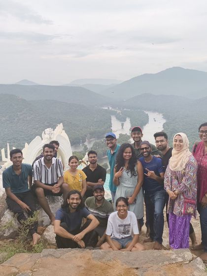 A happy group at the top of Makalidurga, with the river and landscape creating a beautiful backdrop.