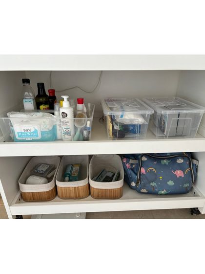 A rolling cart organized with baby's daily essentials. This mobile station can be moved around the house, keeping wipes, creams, and diapers conveniently on hand.