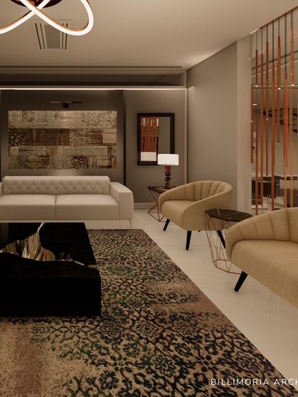 A view of a formal living area where a patterned rug and a sculptural black coffee table anchor the space. We used a mix of neutral-toned sofas and armchairs, with a metallic room divider adding a touch of glamour.