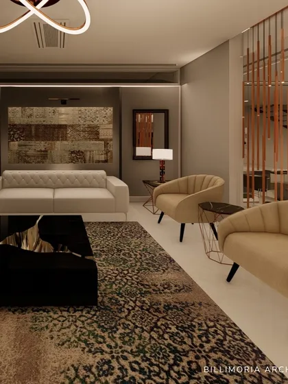 A view of a formal living area where a patterned rug and a sculptural black coffee table anchor the space. We used a mix of neutral-toned sofas and armchairs, with a metallic room divider adding a touch of glamour.