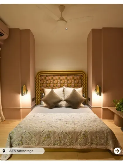 A bedroom with a unique, woven-patterned headboard and soft, blush-pink arched wall details. The design is a beautiful example of modern bohemian style.
