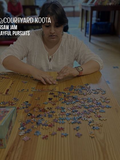 A focused participant at a Jigsaw Jam, demonstrating the quiet, meditative joy of puzzling.