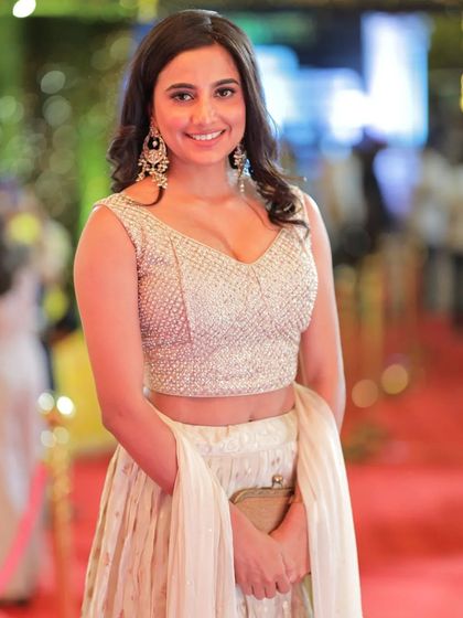 A closer portrait of Shivani Rai, highlighting her radiant smile and elegant earrings.