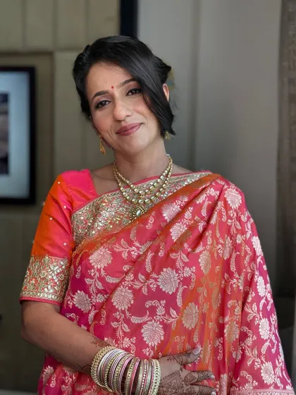 It's always special to get the bride's mom ready. For her, we created an elegant and graceful look with soft makeup and a classic updo that complemented her beautiful silk saree.