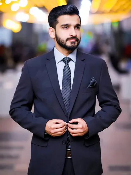 A groom looking sharp in a navy suit. This is a versatile look that works for many formal occasions, from the engagement to the reception.