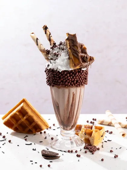 A loaded chocolate freakshake. This type of shot is all about excess and indulgence, perfect for a younger audience.