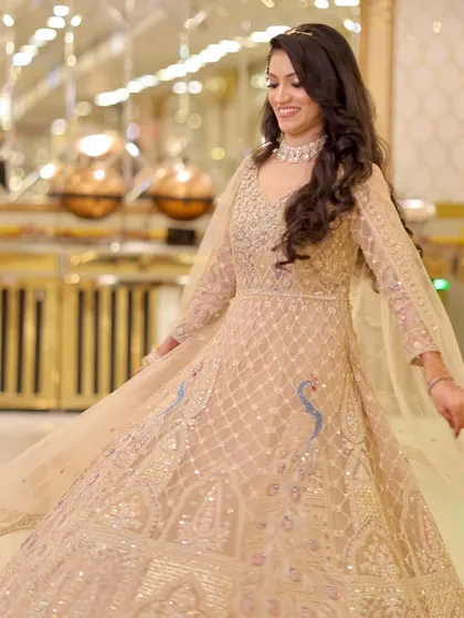 A twirl to show off the stunning beige Anarkali gown. The makeup is kept timeless and elegant to match.