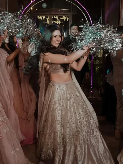 A close-up of the bride and her squad making a grand entrance with silver pom-poms.