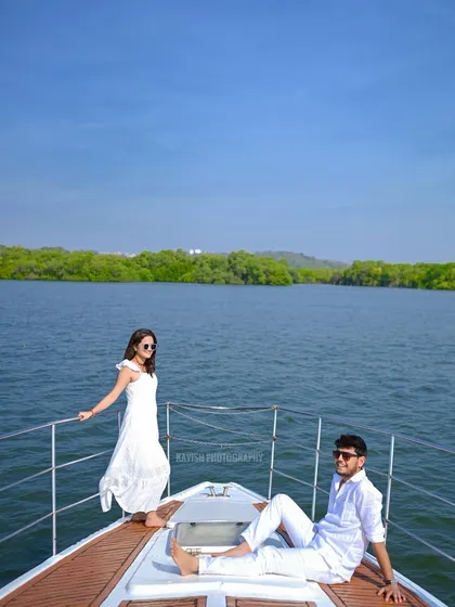 A relaxed and stylish portrait of the couple enjoying their time on a boat, capturing the essence of a luxury pre-wedding experience.