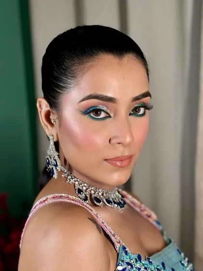 A still from the modern Mehendi glam shoot. The combination of pink blush and blue eyeliner is playful and perfect for a festive, daytime look.