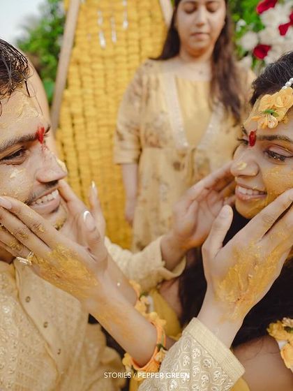 A playful moment during Medhus and Adi's Haldi, as they lovingly apply turmeric to each other's faces. These are the fun, candid memories that make a wedding film special.