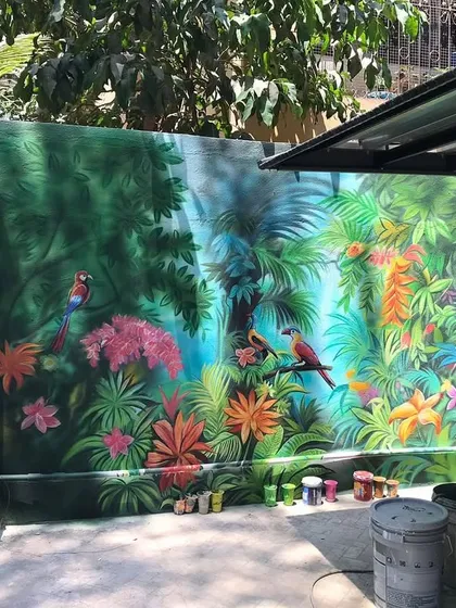 A wider view of the exterior jungle mural, showing how the artwork transforms the entire outdoor space into a tropical paradise.