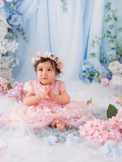 A moment of quiet contemplation for this little girl, sitting among a sea of pink and blue flowers.