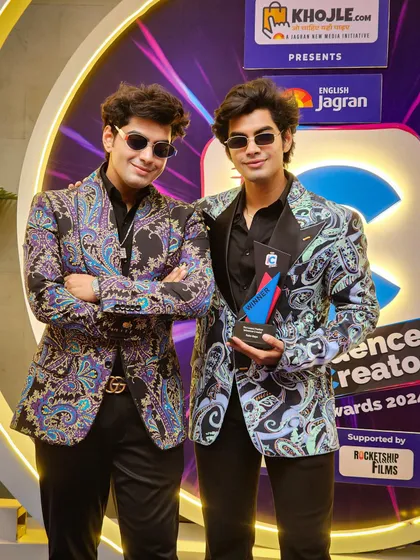 The Sobo Guys in my multi-colored printed jackets. These pieces are designed to be bold and expressive, featuring a fusion of deep blues, purples, and greys in an intricate paisley pattern for a standout red carpet moment.