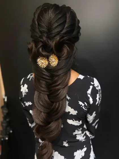 The final photo of the intricate long braid, adorned with golden accessories. A true work of hair art.