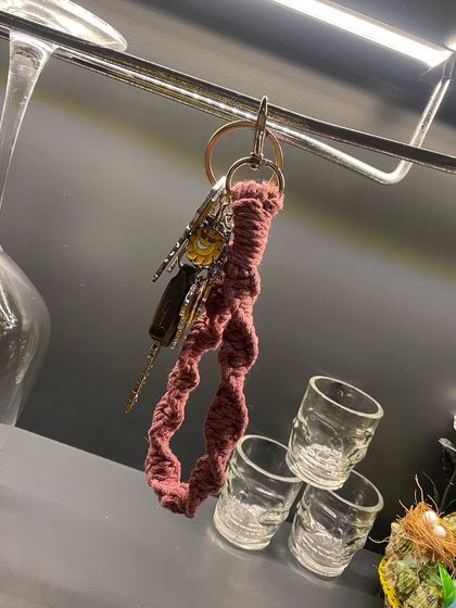 A lifestyle shot of my pink macrame wristlet keychain, conveniently hanging with a set of car keys.
